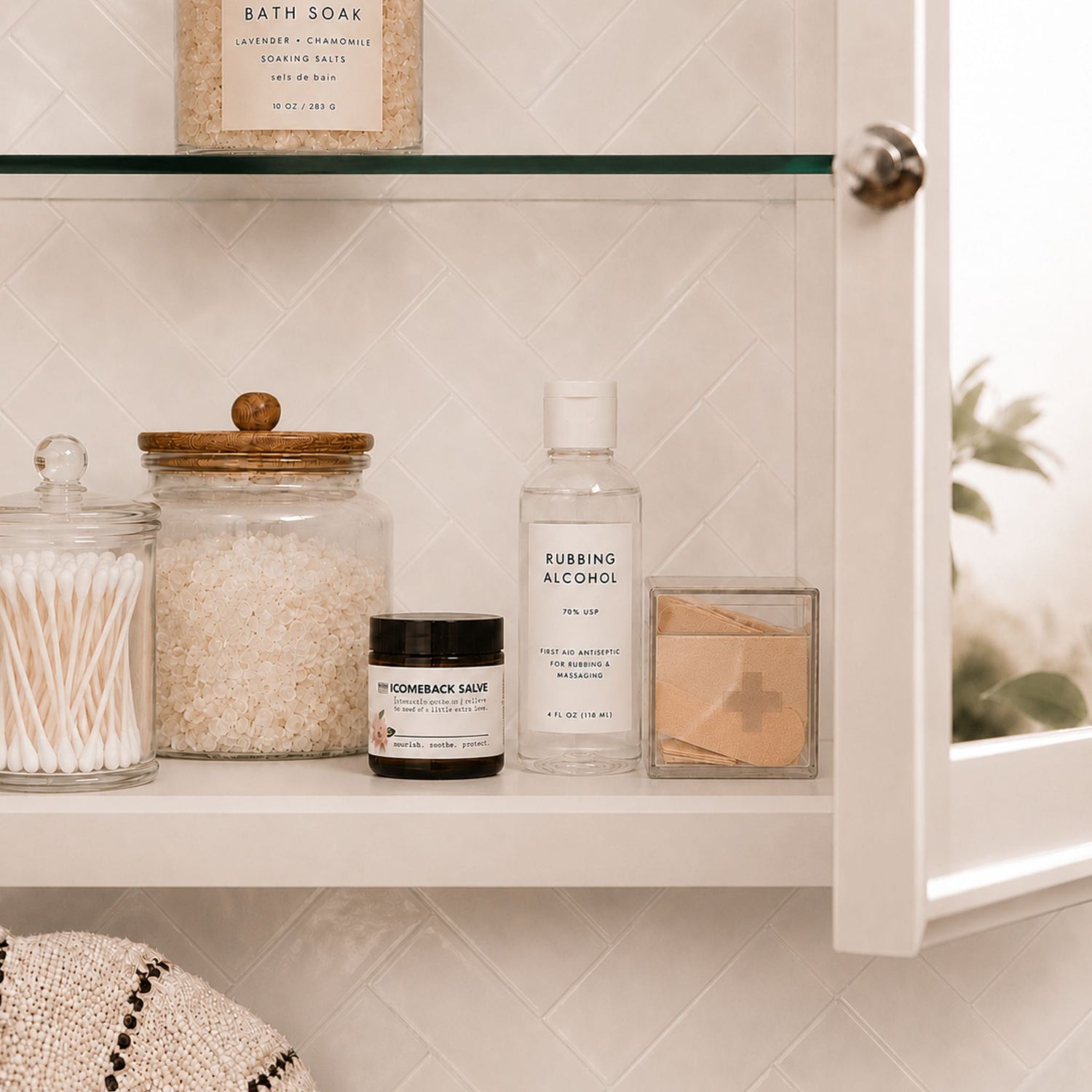 Bathroom cabinet with various items including jars, bottles, and a box on a tiled wall background.