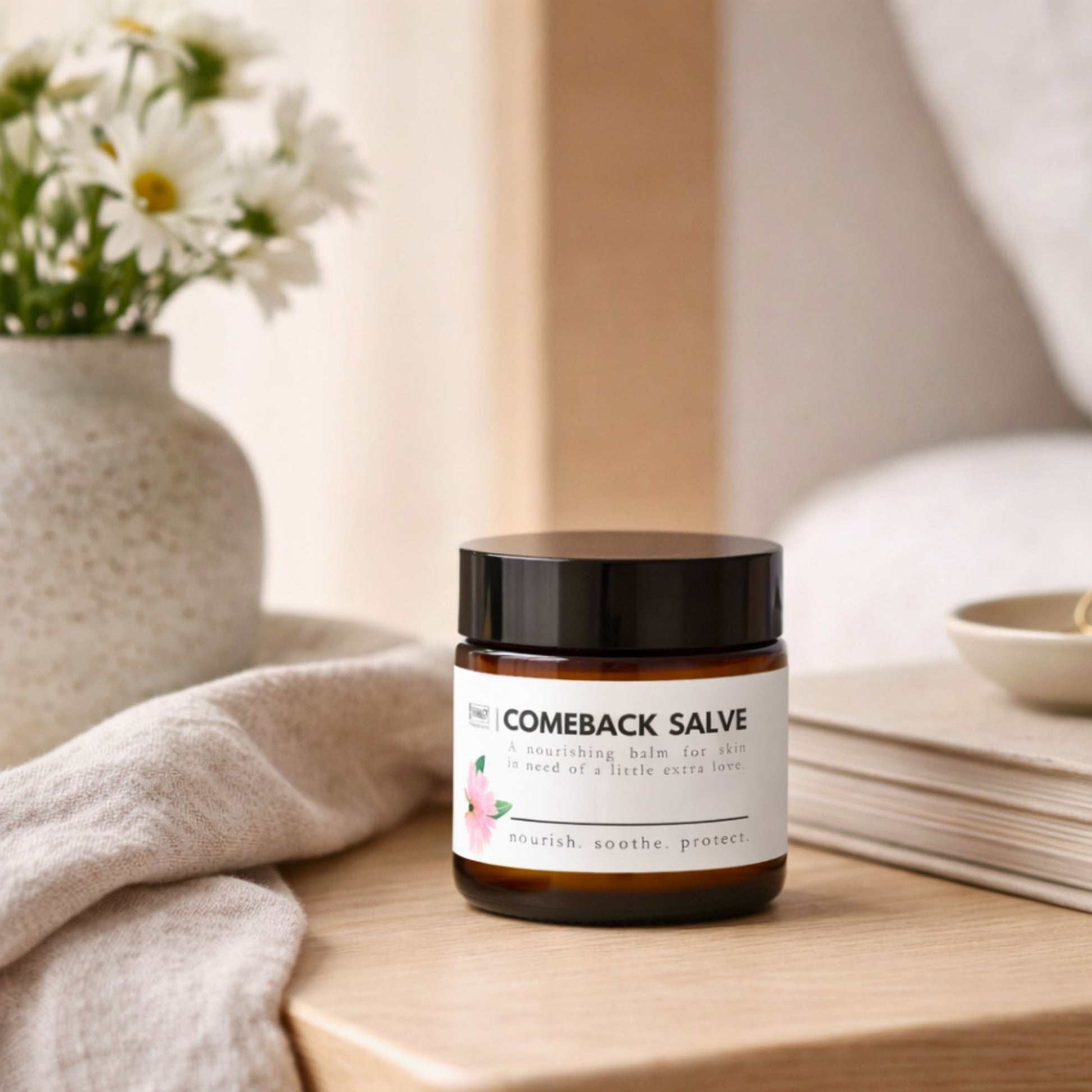 Jar of 'Comeback Salve' on a wooden surface with a neutral background