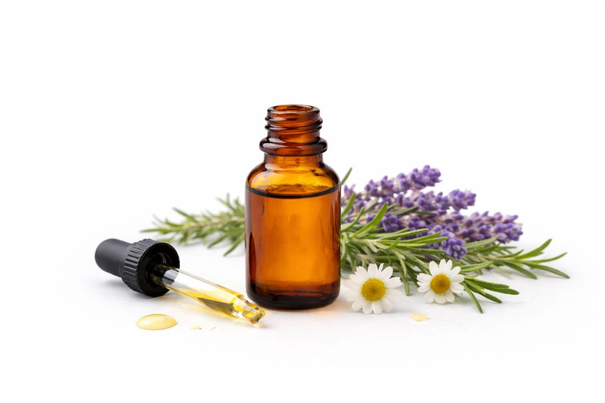 Amber glass dropper bottle with lavender and flowers on a white background