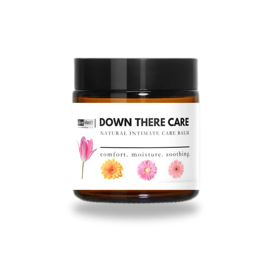 Down There Care external intimate oil balm by Olive Farmacy in an amber glass jar with a white label
